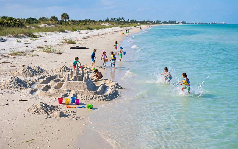 Kids building a sandcastle on a Sarasota beach