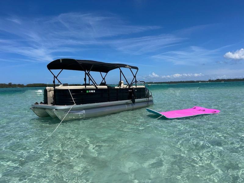 Boat on clear water near a sandbar